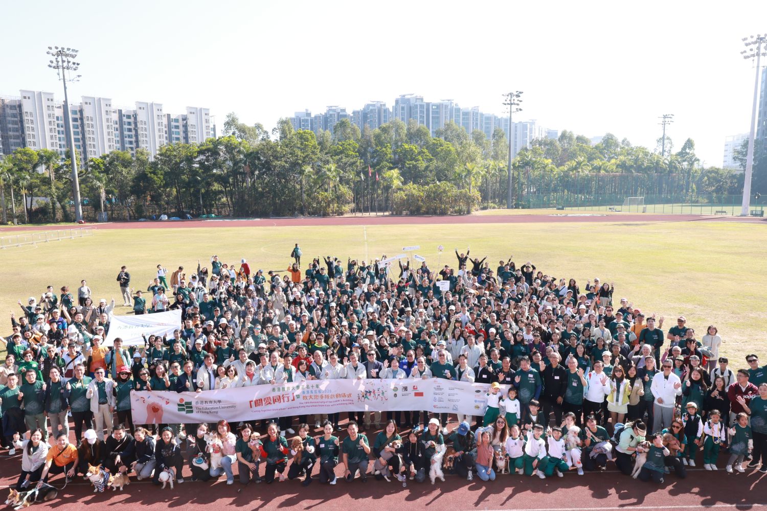 Participants and their dogs join for a group photo, showcasing people pet inclusion and a spirit of community care